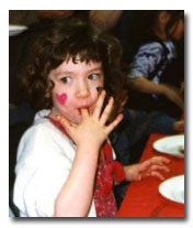 little girl licking chocolate off her finger