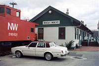 caboose, car and building in Rocky Mount
