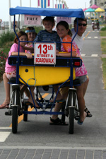 family on tandem riding on the VA Beach Boardwalk