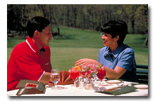 couple dining at a table overlooking golf course at Wintergreen